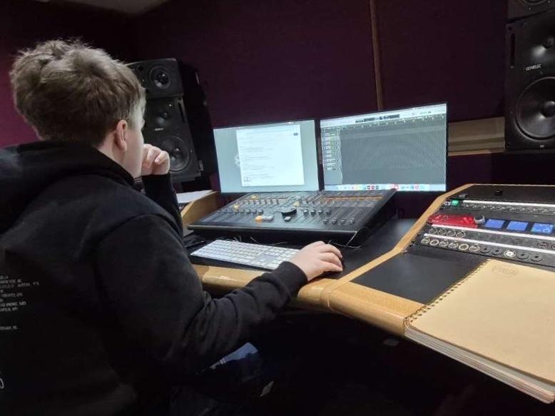 David Dugnas working at a mixing console in a recording studio