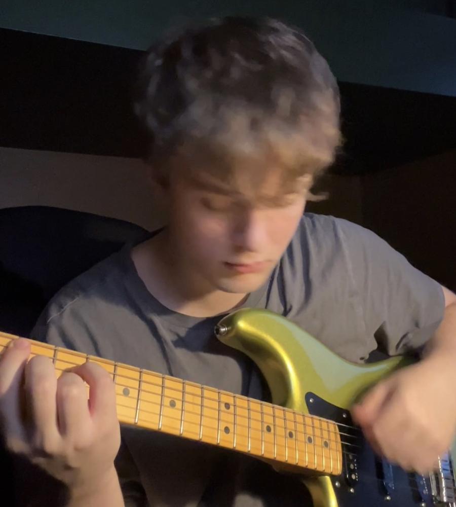 David Dugnas playing electric guitar