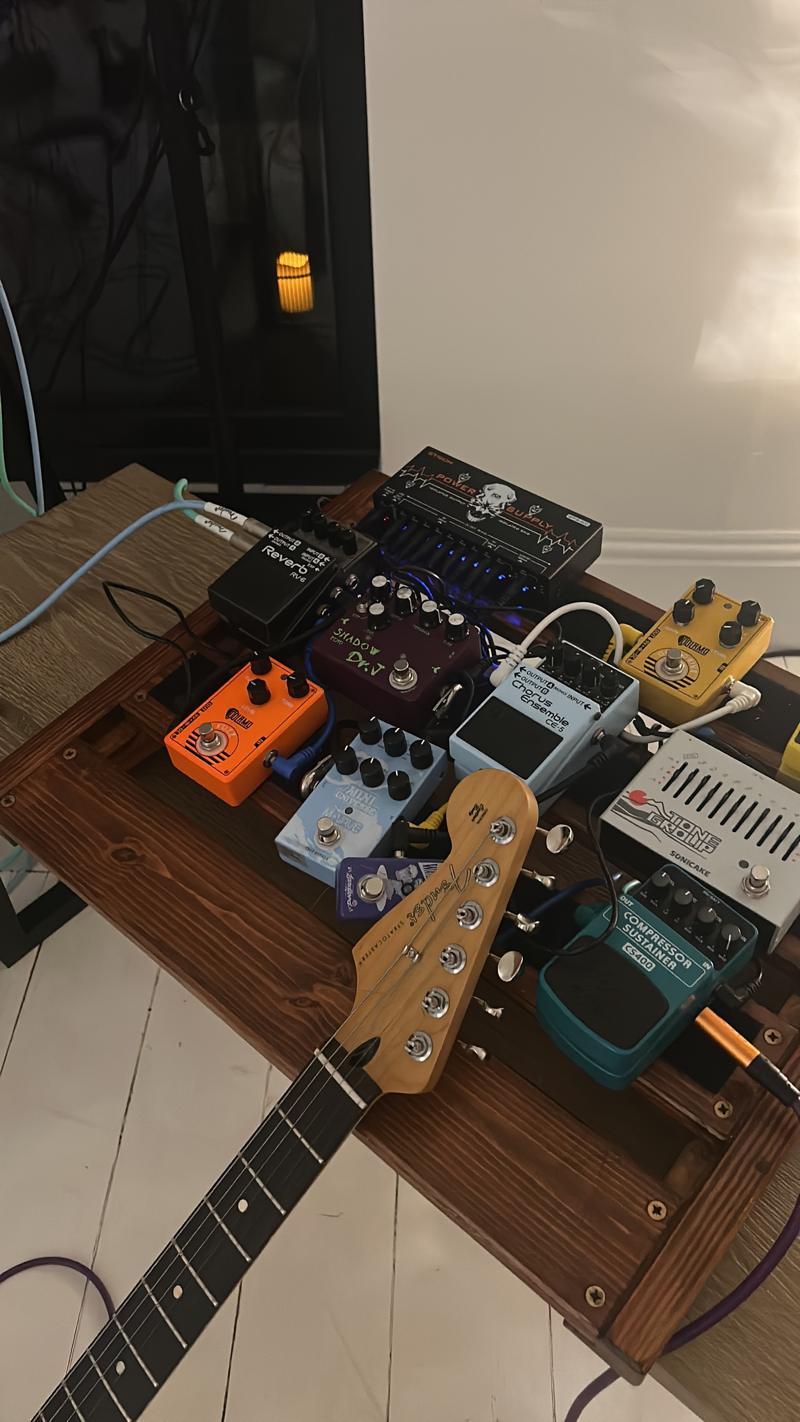 Guitar pedalboard and a Stratocaster-style guitar neck